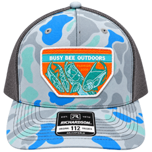 Front view of Busy Bee Outdoors Richardson 112 trucker hat with blue, aqua and gray camouflage, embroidered fishing patch and charcoal mesh back.