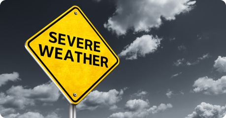 Yellow and black Severe Weather warning road sign